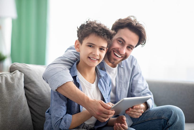 family-time-happy-dad-and-son-using-digital-tablet-browsing-internet-online-at-home-sitting.jpg